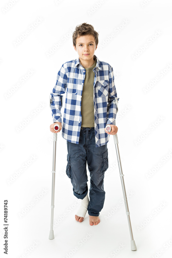 Teenage Boy with crutches and a bandage on his right leg Teenage Boy with crutches and a bandage on his right leg
