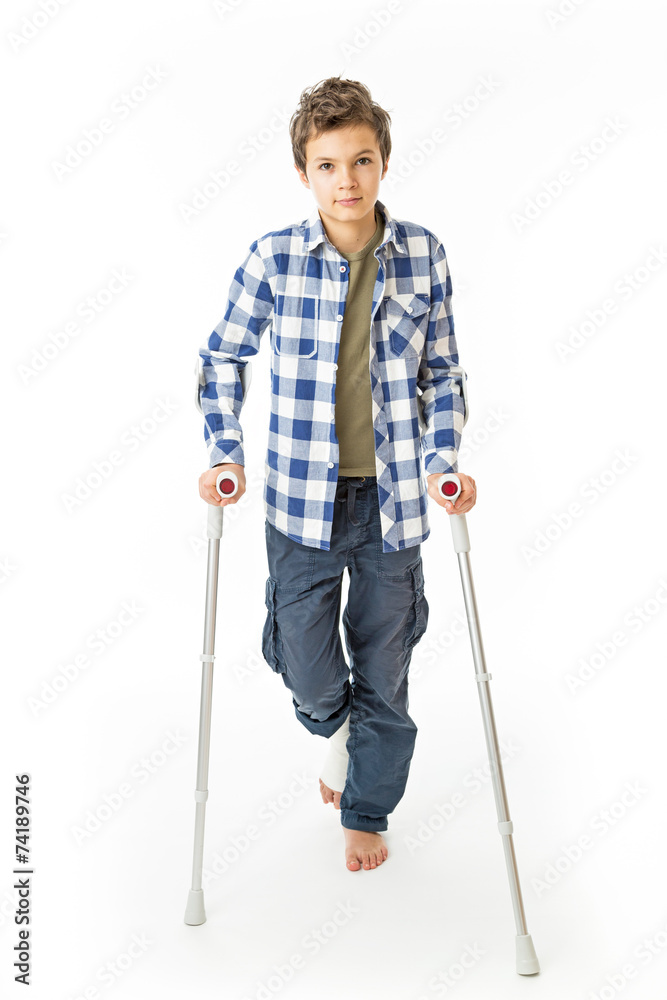 Teenage Boy with crutches and a bandage on his right leg Teenage Boy with crutches and a bandage on his right leg