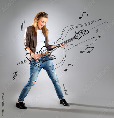 Woman listening to music on mp3 player, dancing playing air guit