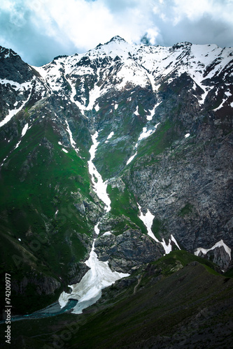 Mountain pass with the glacier and green grass. Fann Mountains.