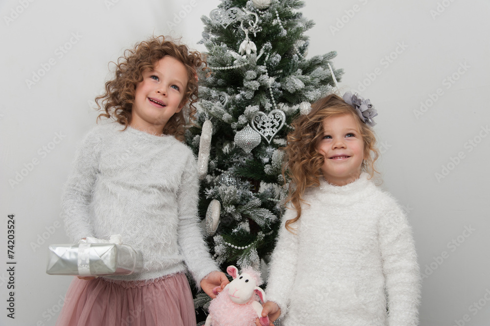 Two cute child girls with gifts, Christmas tree Two cute child girls with gifts, Christmas tree