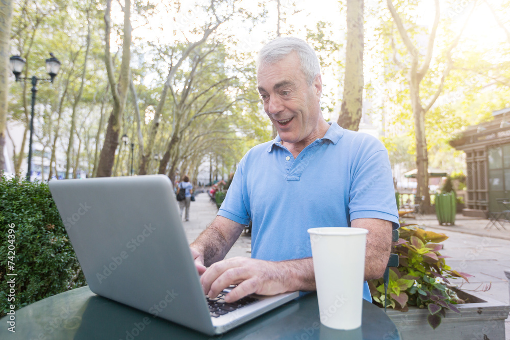 American Senior Man with Computer at Park