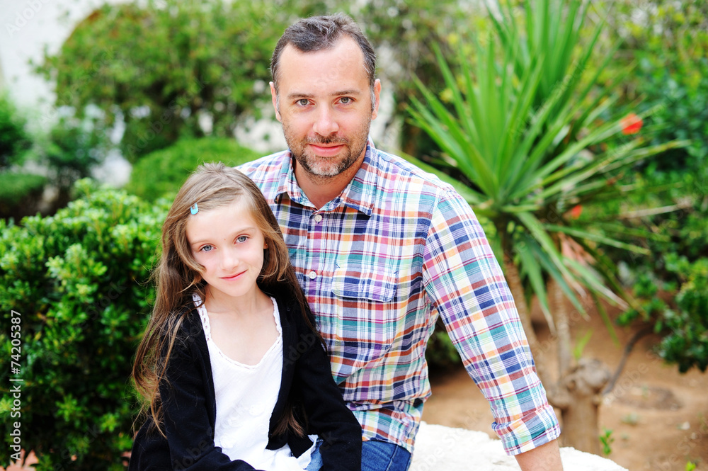 Fototapeta premium Father and daughter together outside in summer day