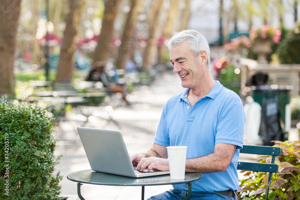 American Senior Man with Computer at Park American Senior Man with Computer at Park