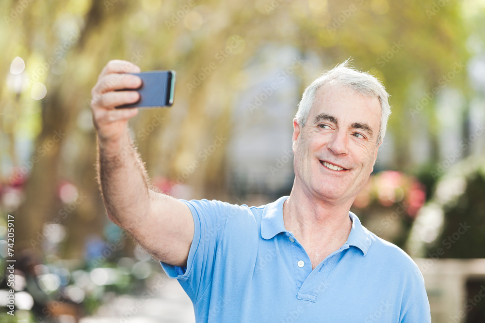 Fototapeta premium Senior Man Taking a Selfie at Park