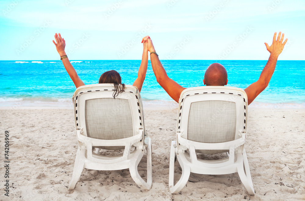 Couple relaxing on sunbed