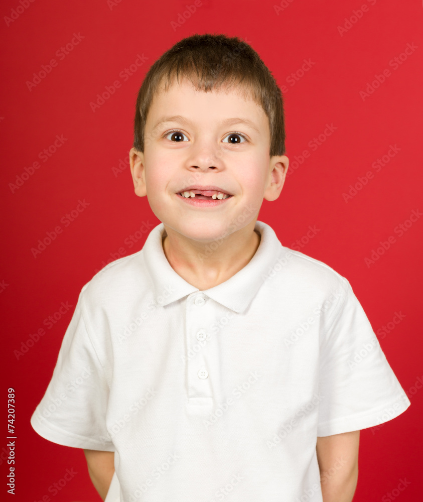 grimacing boy portrait on red grimacing boy portrait on red