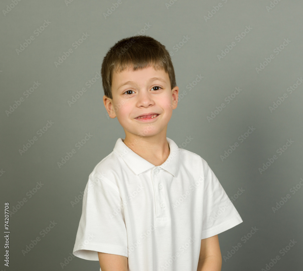 grimacing boy portrait on grey