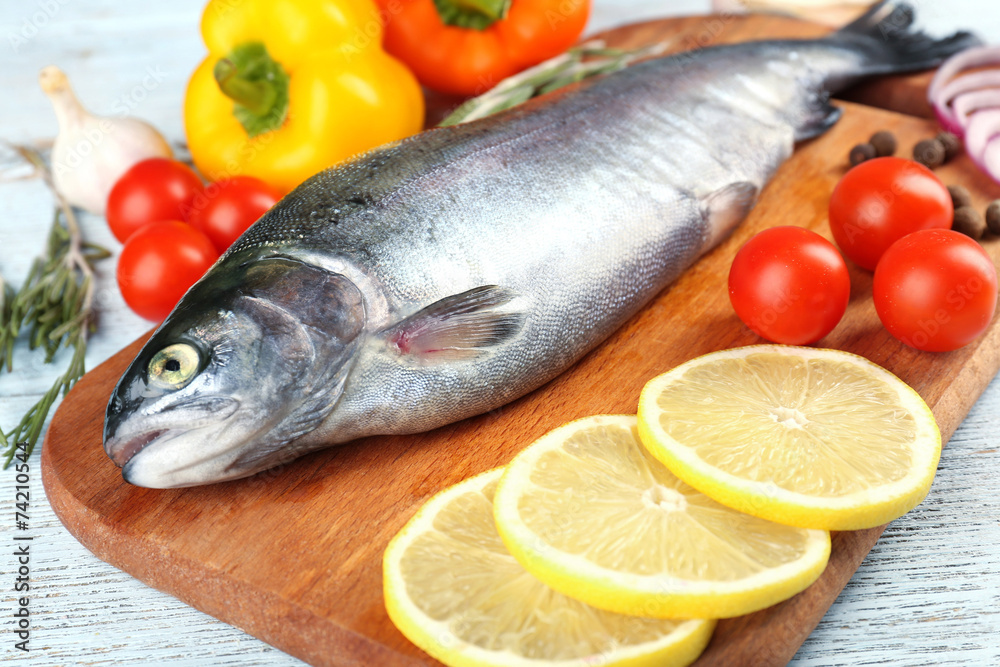 Fresh raw fish and food ingredients on table Fresh raw fish and food ingredients on table