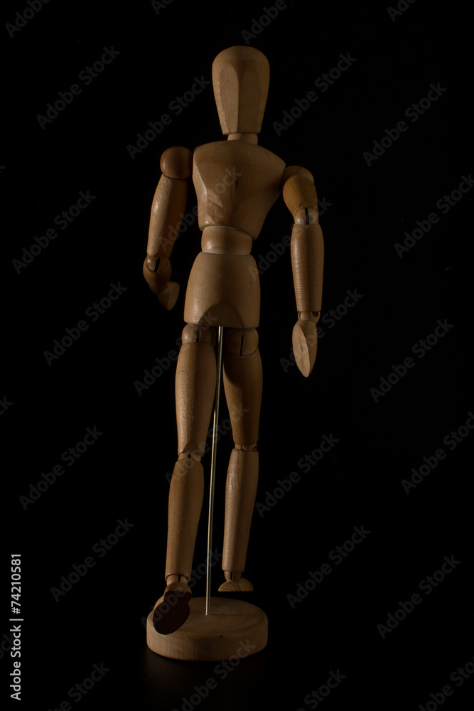 wooden mannequin running on a black background wooden mannequin running on a black background