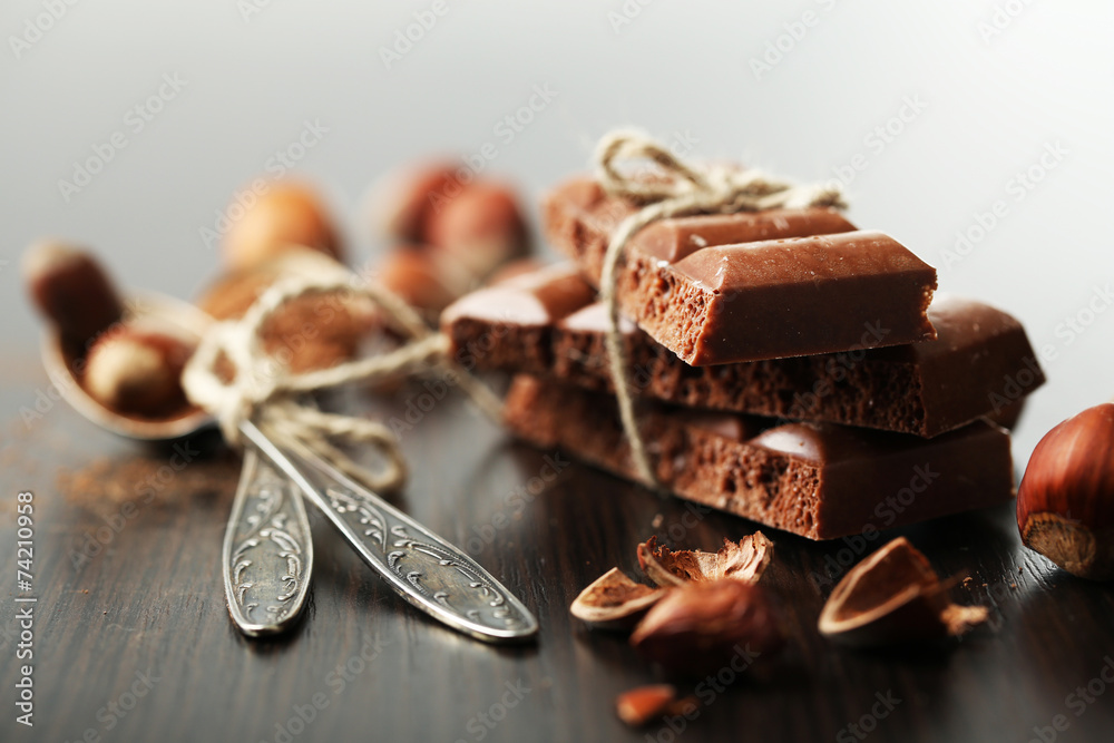 Tasty porous chocolate with nuts on table, close up Tasty porous chocolate with nuts on table, close up
