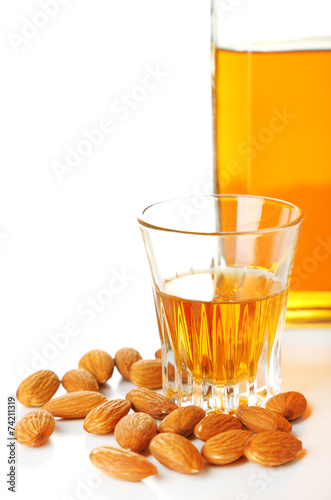 Fototapeta Naklejka Na Ścianę i Meble -  Dessert liqueur Amaretto with almond nuts, isolated on white