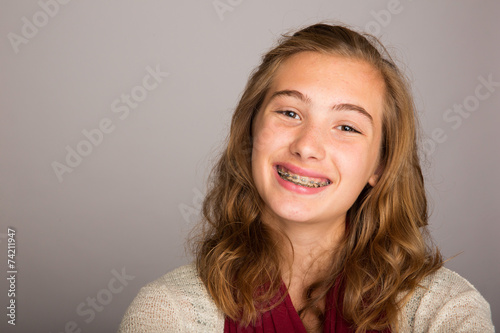 happy teenage girl wearing braces