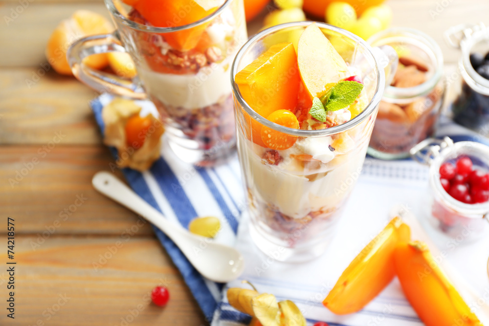Healthy layered dessert with muesli and fruits on table Healthy layered dessert with muesli and fruits on table