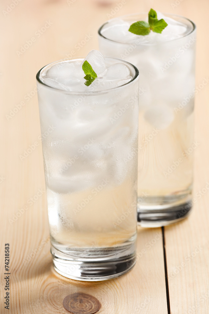 Glasses with ice cubes on wooden table Glasses with ice cubes on wooden table