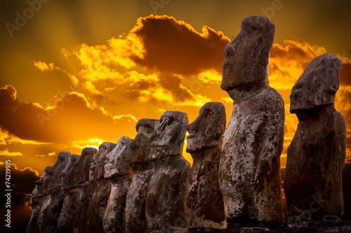 Standing moais with orange clouds in background in Easter Island photo