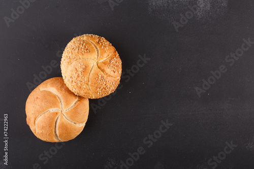 kaiser bread on dark chalkboard photo