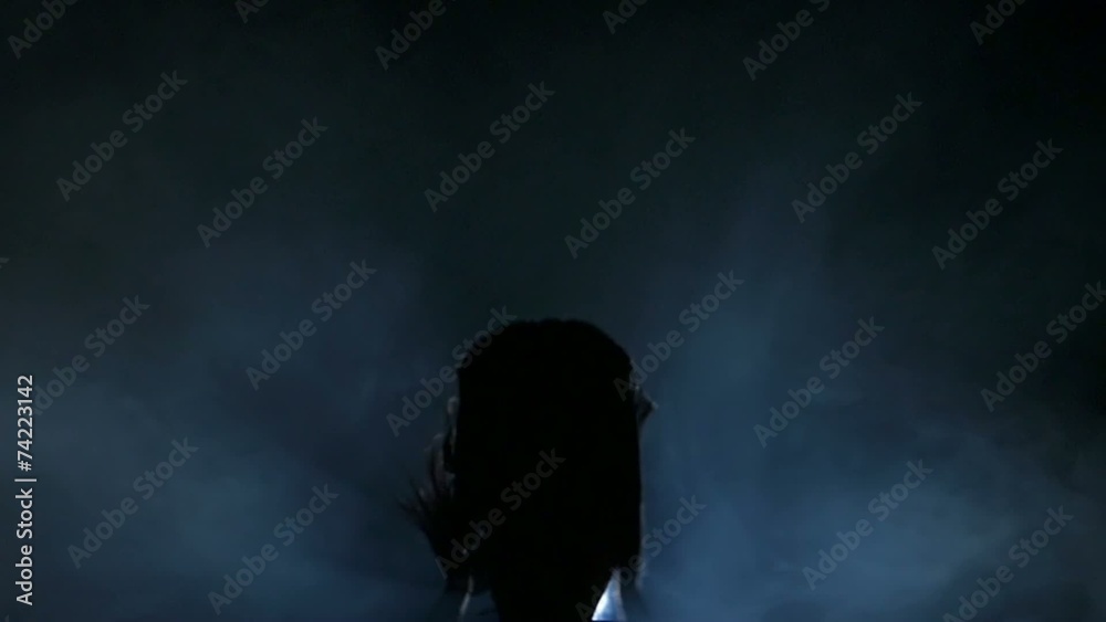 Dancing silhouettes of woman in a nightclub. Slow motion.