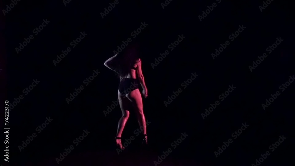 Beautiful brunette woman with handcuffs and  huge afro haircut.