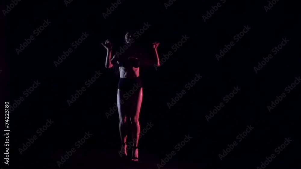 Sexy woman dancing, dark background. Slow motion. Sexy woman dancing, dark background. Slow motion.