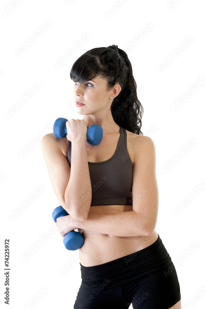 Young attractive girl exercising with pair of dumbbells Young attractive girl exercising with pair of dumbbells