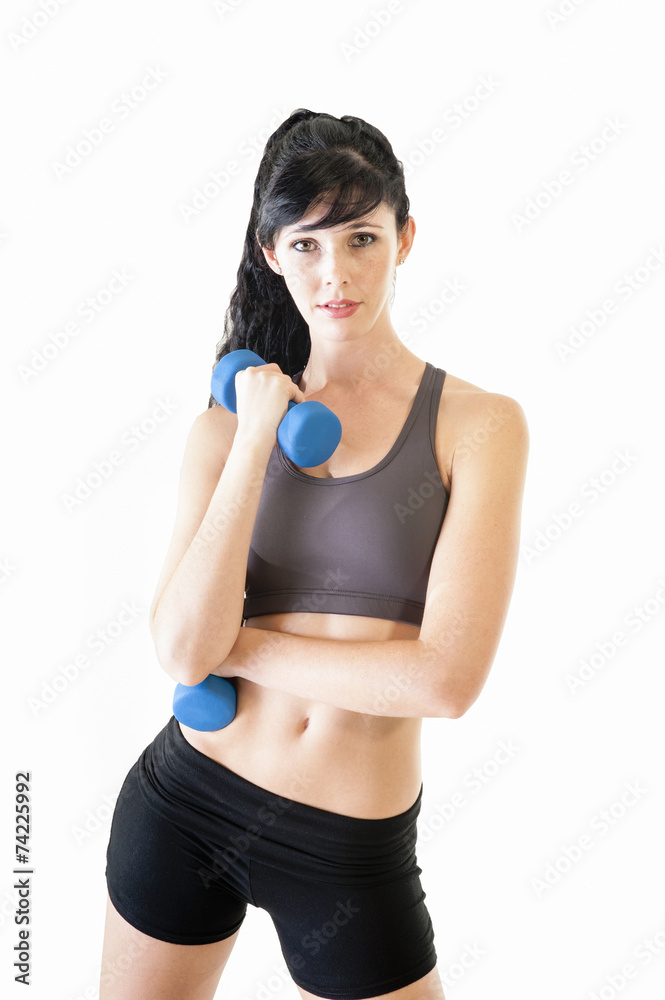 Young attractive girl exercising with pair of dumbbells Young attractive girl exercising with pair of dumbbells