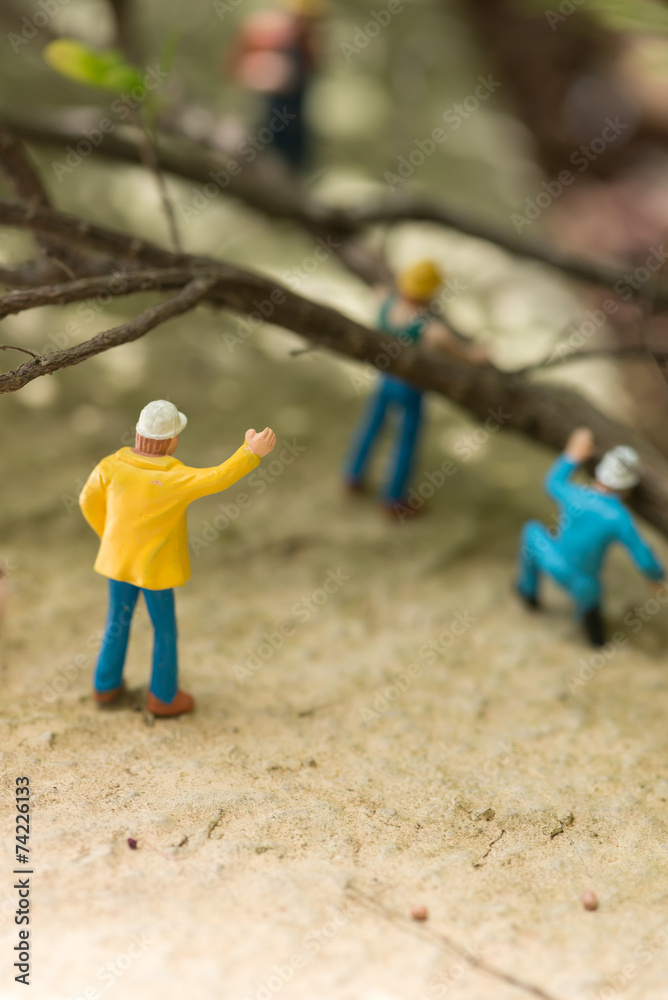 Miniature workers clearing fallen trees Miniature workers clearing fallen trees