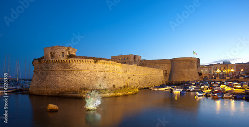 Angevin Castle of Gallipoli by night in Salento, Italy. photo