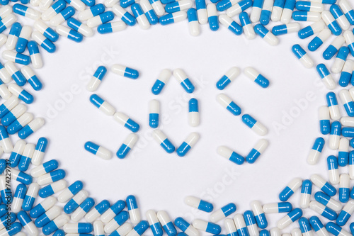 sos word text made of blue tablets, pills and capsules
