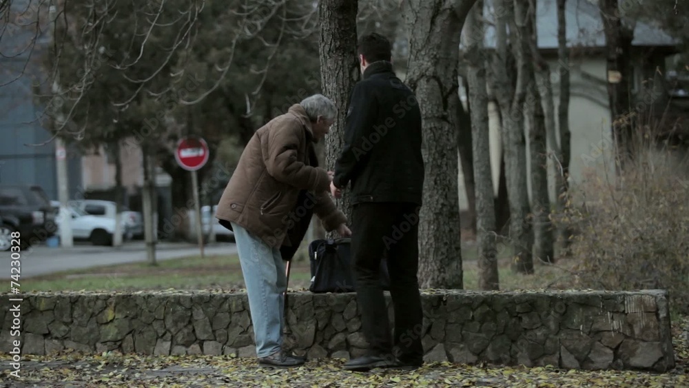 Helping old man in the street Helping old man in the street