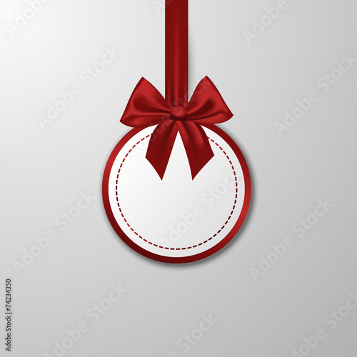 Christmas paper bauble with bow on the white background.