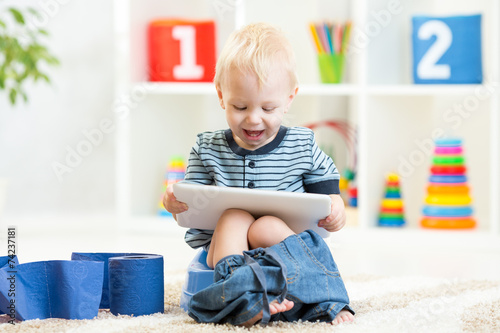 smiling child sitting on ch...