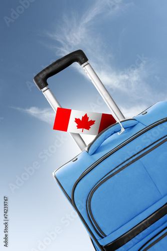 Destination Canada. Blue suitcase with flag.