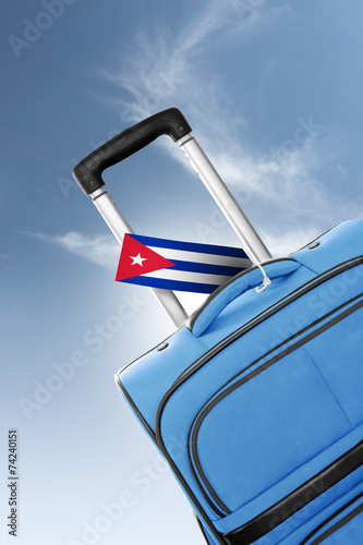 Destination Cuba. Blue suitcase with flag.