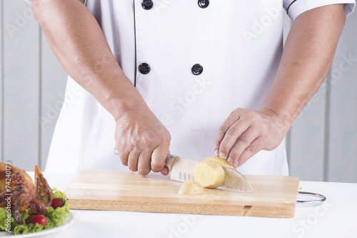 chef cutting potato