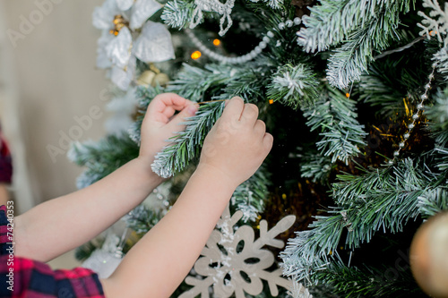 child decorate a Christmas tree