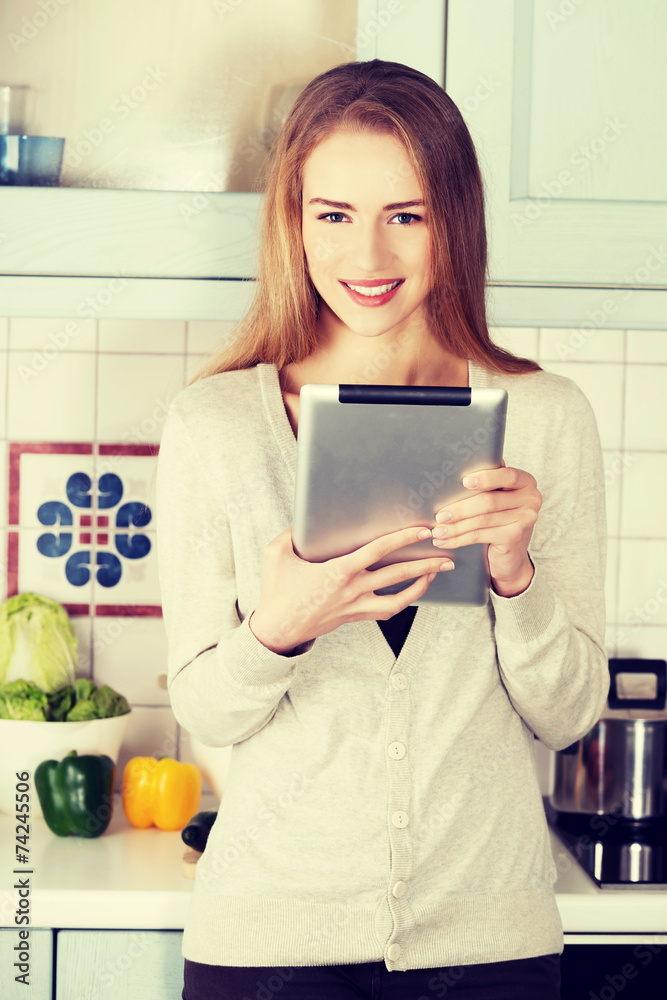 Beautiful caucasian woman working on tablet.