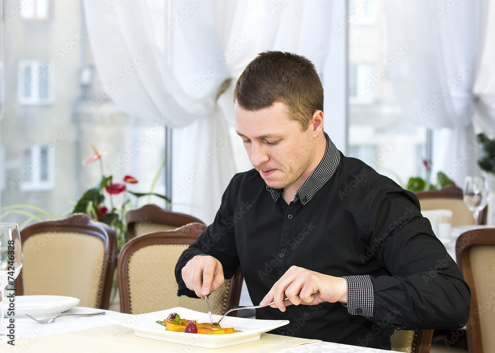 young man having dinner in a restaurant young man having dinner in a restaurant