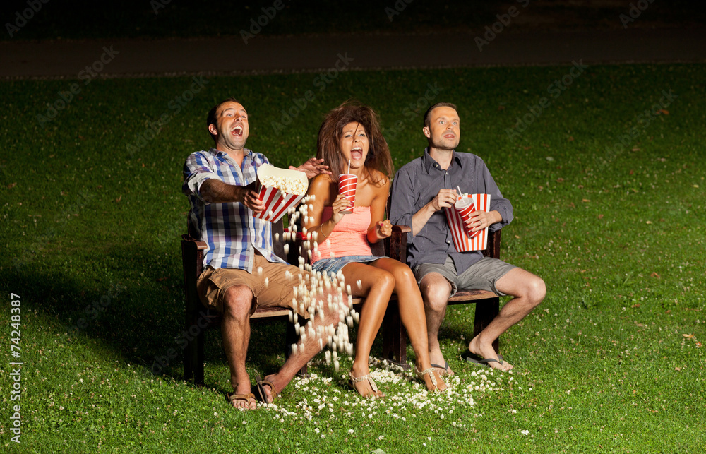 Naklejka premium three friends watching a movie