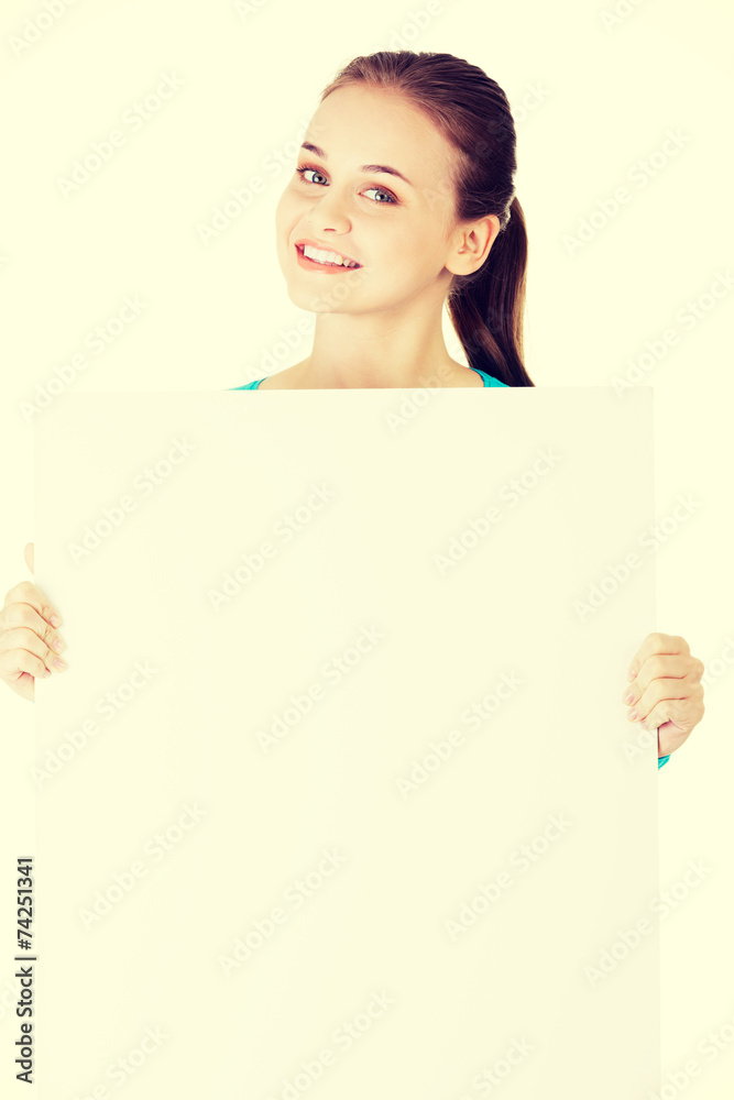 Attractive woman holding a poster with copy space. Attractive woman holding a poster with copy space.