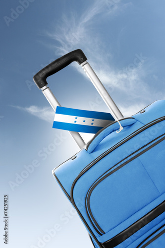 Destination Honduras. Blue suitcase with flag.