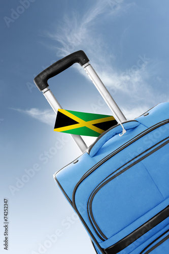 Destination Jamaica. Blue suitcase with flag.