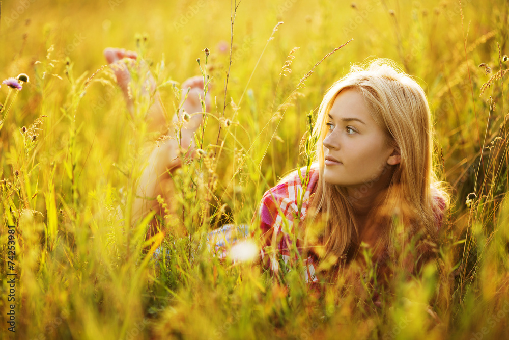 Happy girl in a field of grass and flowers Happy girl in a field of grass and flowers
