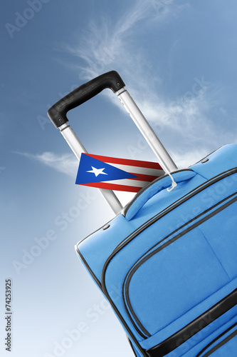 Destination Puerto Rico. Blue suitcase with flag.