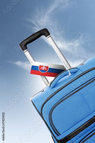 Destination Slovakia. Blue suitcase with flag.