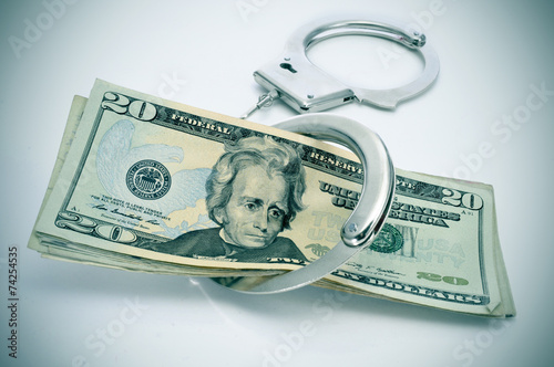 handcuffs and dollar bills photo