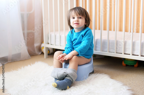 little boy sitting on potty