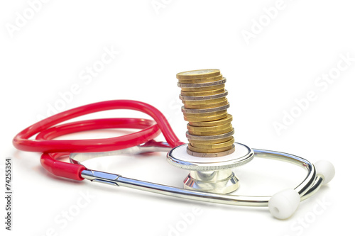 MEDICAL EXPENSES 4 - A stethoscope with a pile of coins on top.