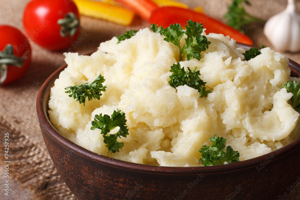 Delicious mashed potatoes with parsley closeup on the table Delicious mashed potatoes with parsley closeup on the table