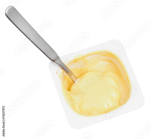 caramel yogurt and spoon in disposable cup